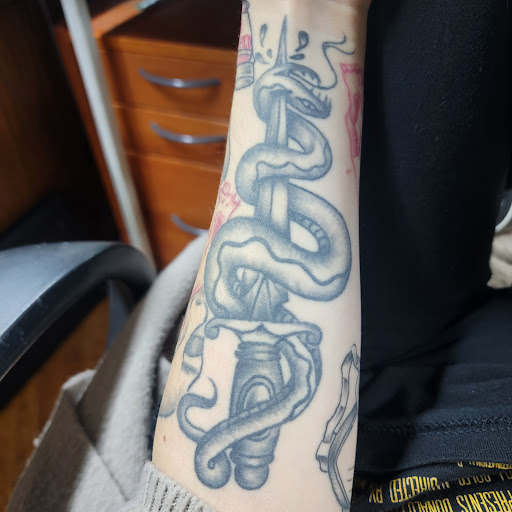 Explore bookish tattoo ideas, creative tattoo ideas in Akron, available at Tattoos by Mastle