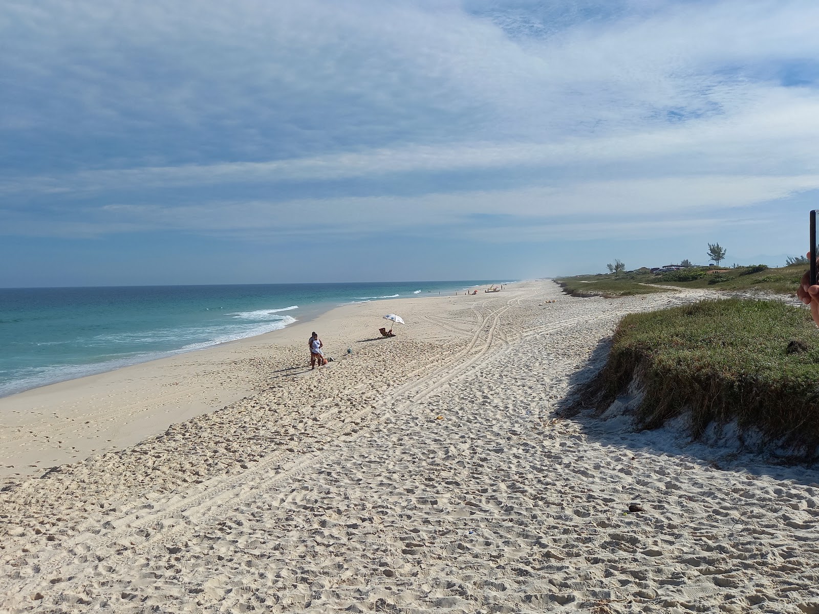 Photo of Dentinho Beach with long straight shore