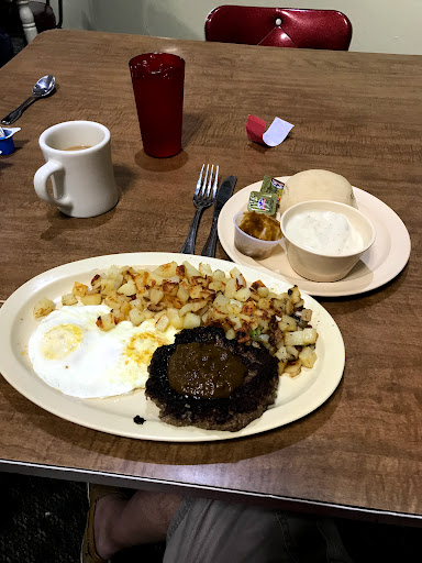 Hamburger patty with eggs and biscuits and gravy 