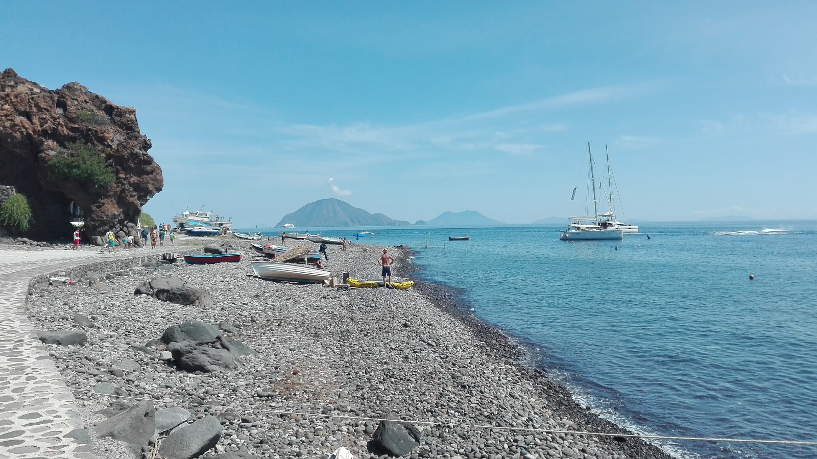 Photo of Alicudi Harbor beach with gray pebble surface