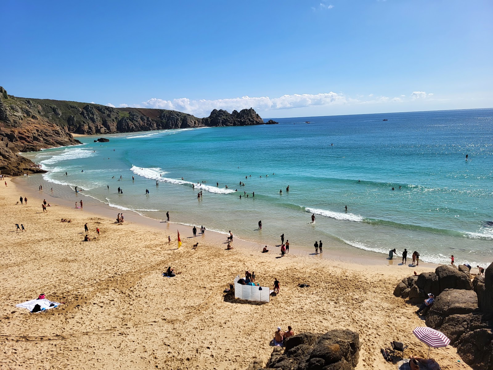 Photo of Porthcurno Beach with bright sand surface
