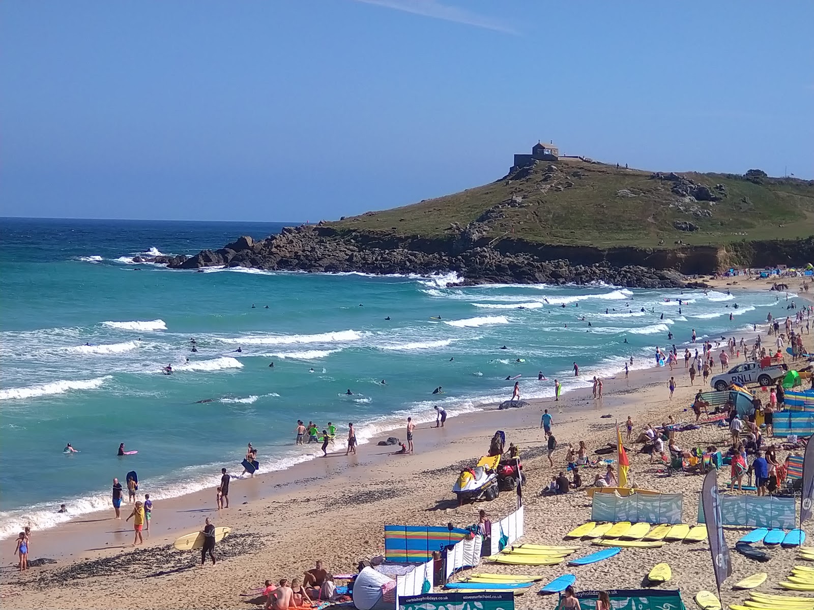 Photo of Porthmeor beach surrounded by mountains