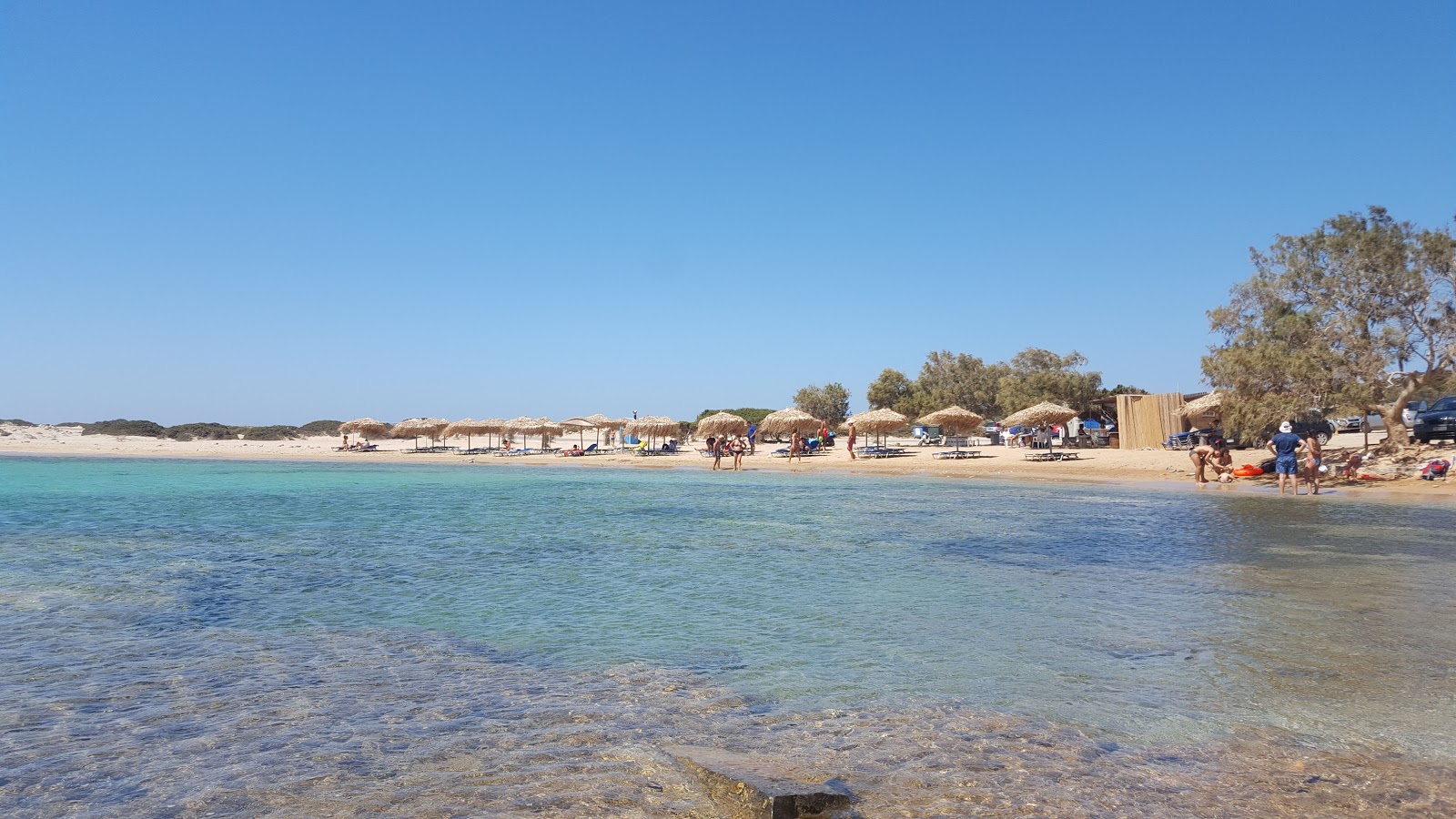 Photo of Kalotaritissa Beach with bright sand & rocks surface