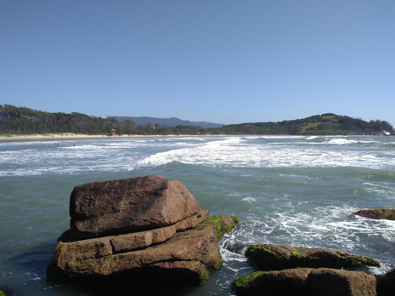 Photo of Ouvidor Beach backed by cliffs