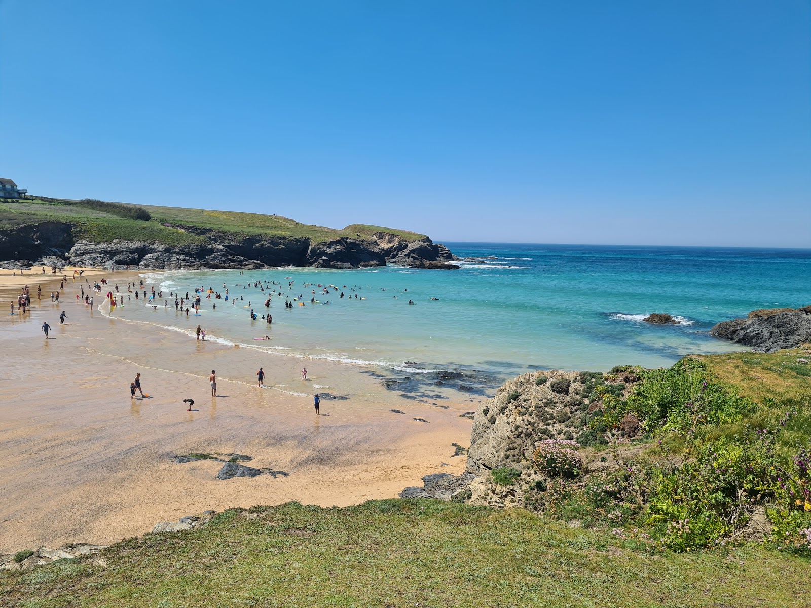 Photo of Treyarnon Bay with bright fine sand surface