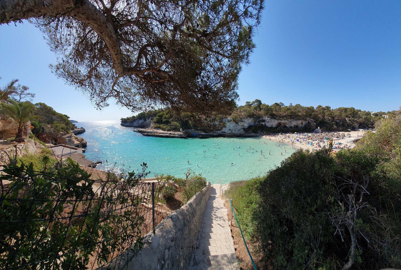 Photo of Cala Llombards beach with turquoise pure water surface