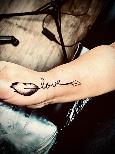 Explore forearm name tattoo ideas, creative tattoo ideas in Lake City, available at Crooked Spines Tattoo Studio