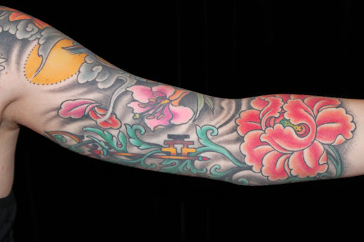 Explore colorful flower tattoo ideas, creative tattoo ideas in Boulder, available at Rising Tide Tattoo Emporium