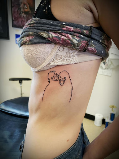 Explore neck name tattoo ideas, creative tattoo ideas in Flint, available at Black Eye Social Club Tattoo