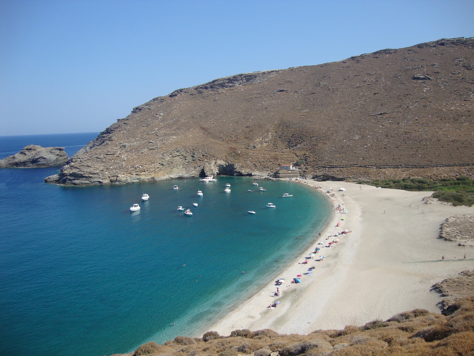 Photo of Achla beach backed by cliffs