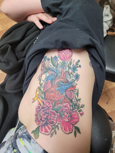 Explore hand tattoo ideas for guys, creative tattoo ideas in Covington, available at Cupid Slave Tattoo Company