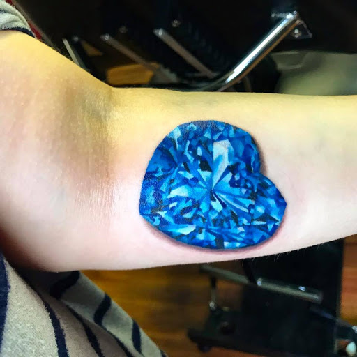 Find in between boob tattoo ideas for your next unique tattoo in Sanford at Venom Ink Tattoo