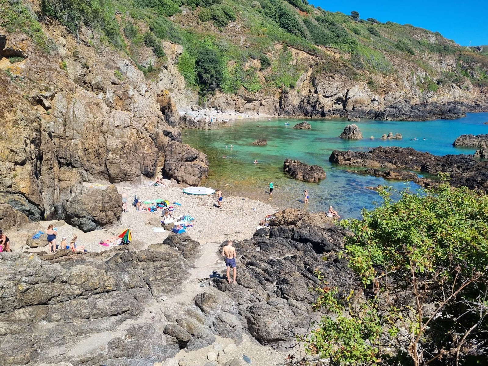 Photo of Moulin Huet Bay with gray sand &  rocks surface