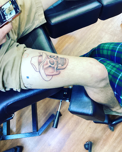 Explore tattoo scroll ideas, creative tattoo ideas in Cocoa, available at Rorschach Tattoo Shop and Piercing Studio