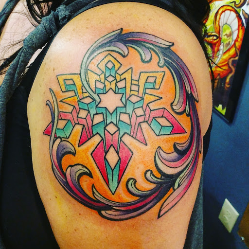 Explore orchid tattoo ideas, creative tattoo ideas in Cheyenne, available at The T.R.I.B.E. Zoo, LLC Tattoo