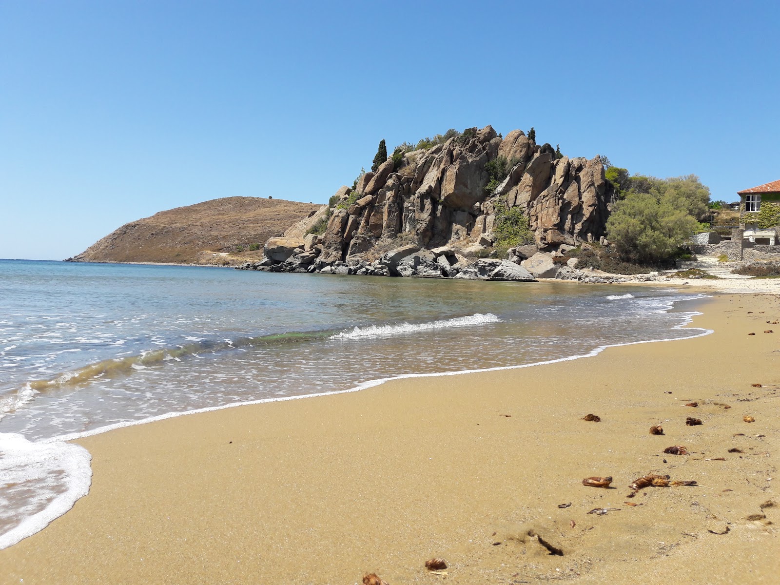 Photo of Myrina beach with brown sand surface