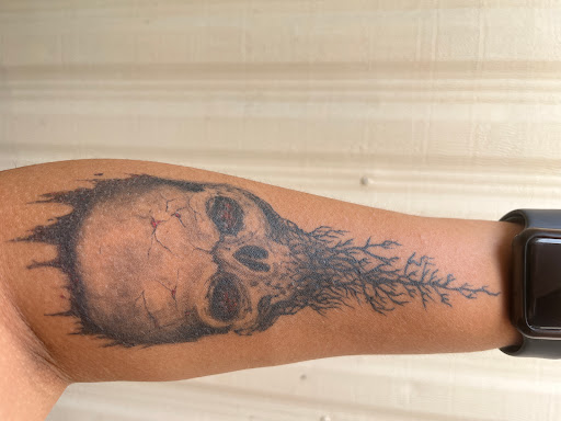 Explore skull neck tattoo ideas, creative tattoo ideas in Girard, available at Cult Tattoo