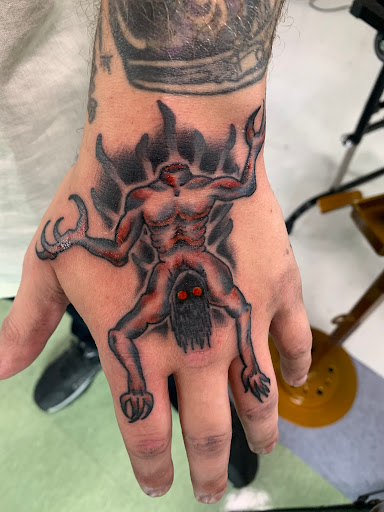 Explore joker hand tattoo ideas, creative tattoo ideas in Muncie, available at Fox & Sparrow Tattoo