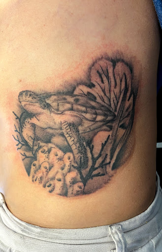 Explore abdomen tattoo ideas, creative tattoo ideas in Palm Harbor, available at Angry Owl Tattoo and Piercing