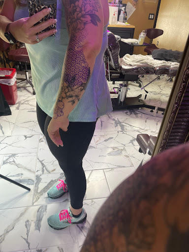 Find tattoo ideas for woman on leg for your next unique tattoo in Titusville at Exclusive Ink Studio
