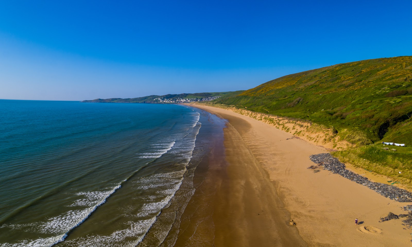 Photo of Putsborough beach with turquoise water surface