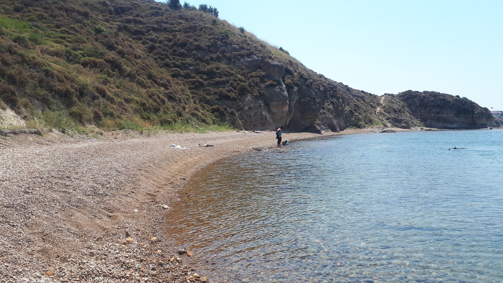 Photo of Misyon beach with brown fine pebble surface