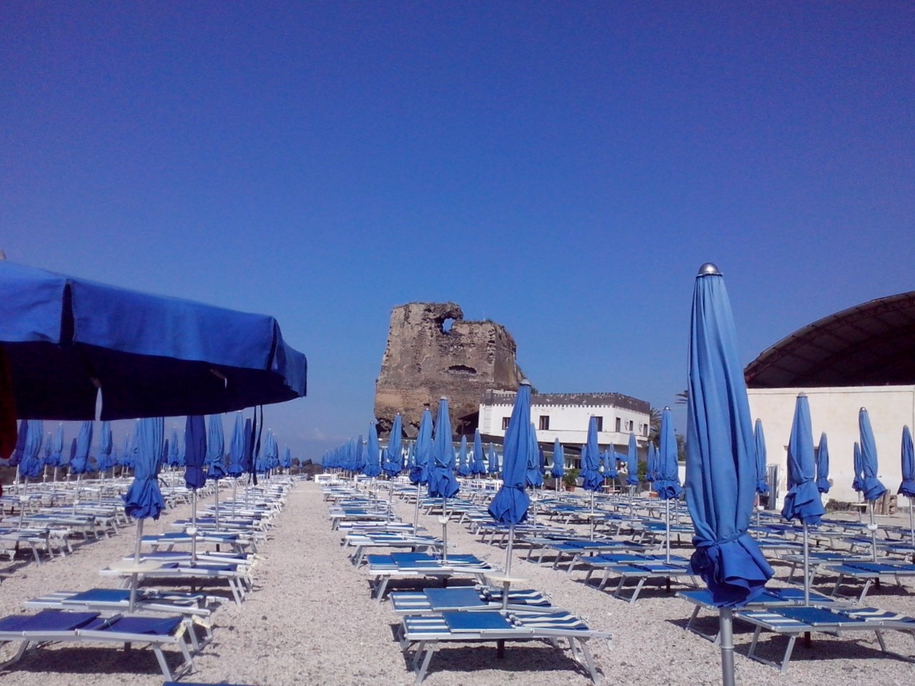 Foto di Torre Saracena con una superficie del ciottoli grigi