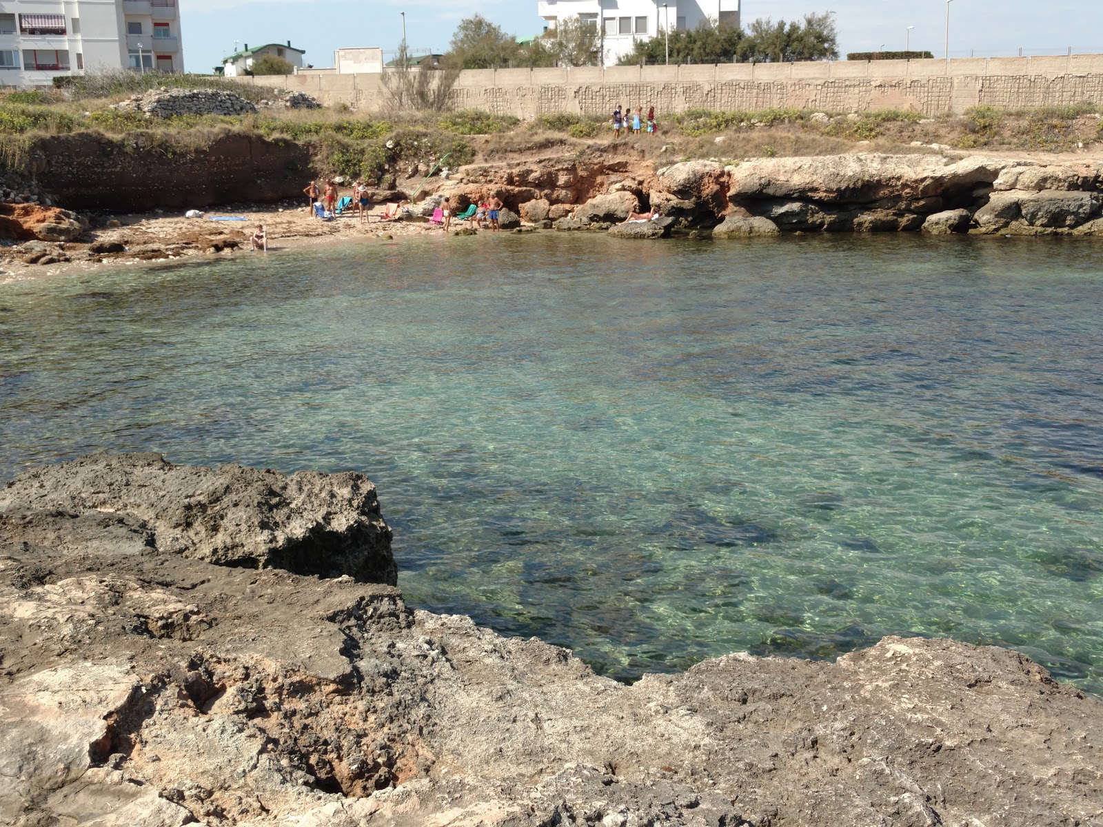 Photo of Cala Scizzo beach with gray sand &  rocks surface