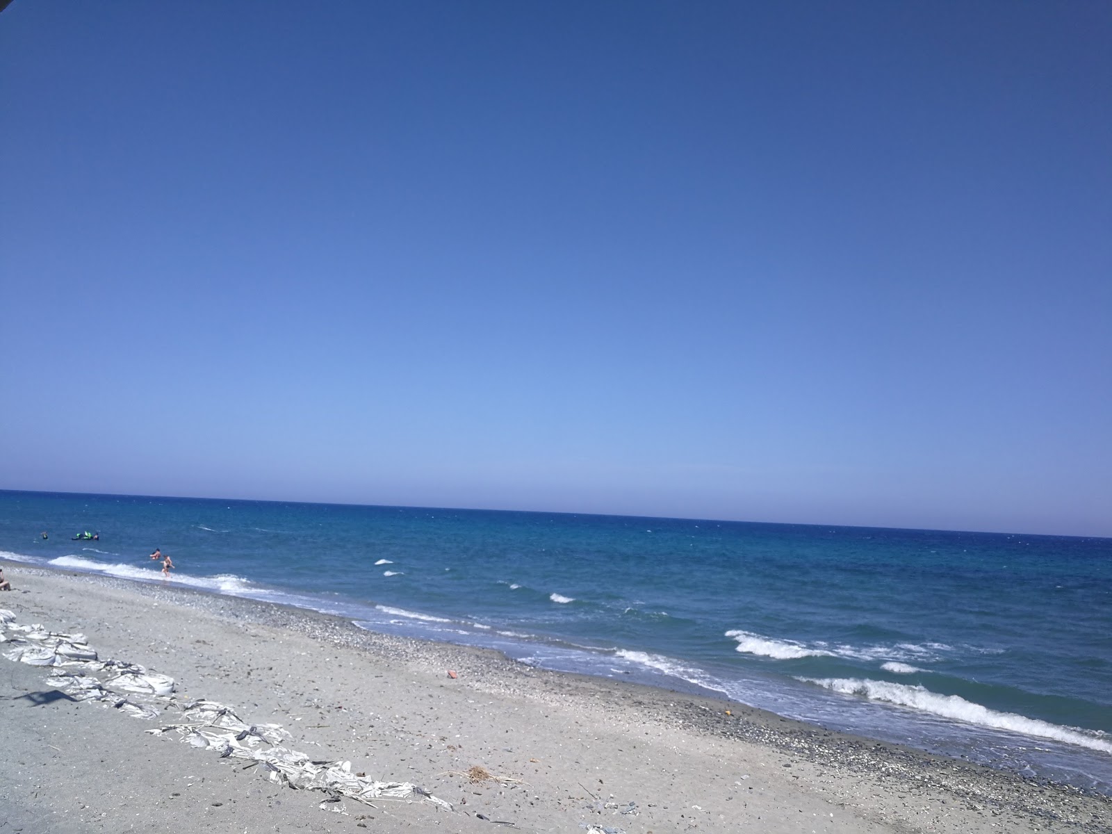 Foto von Moriani Strand mit türkisfarbenes wasser Oberfläche