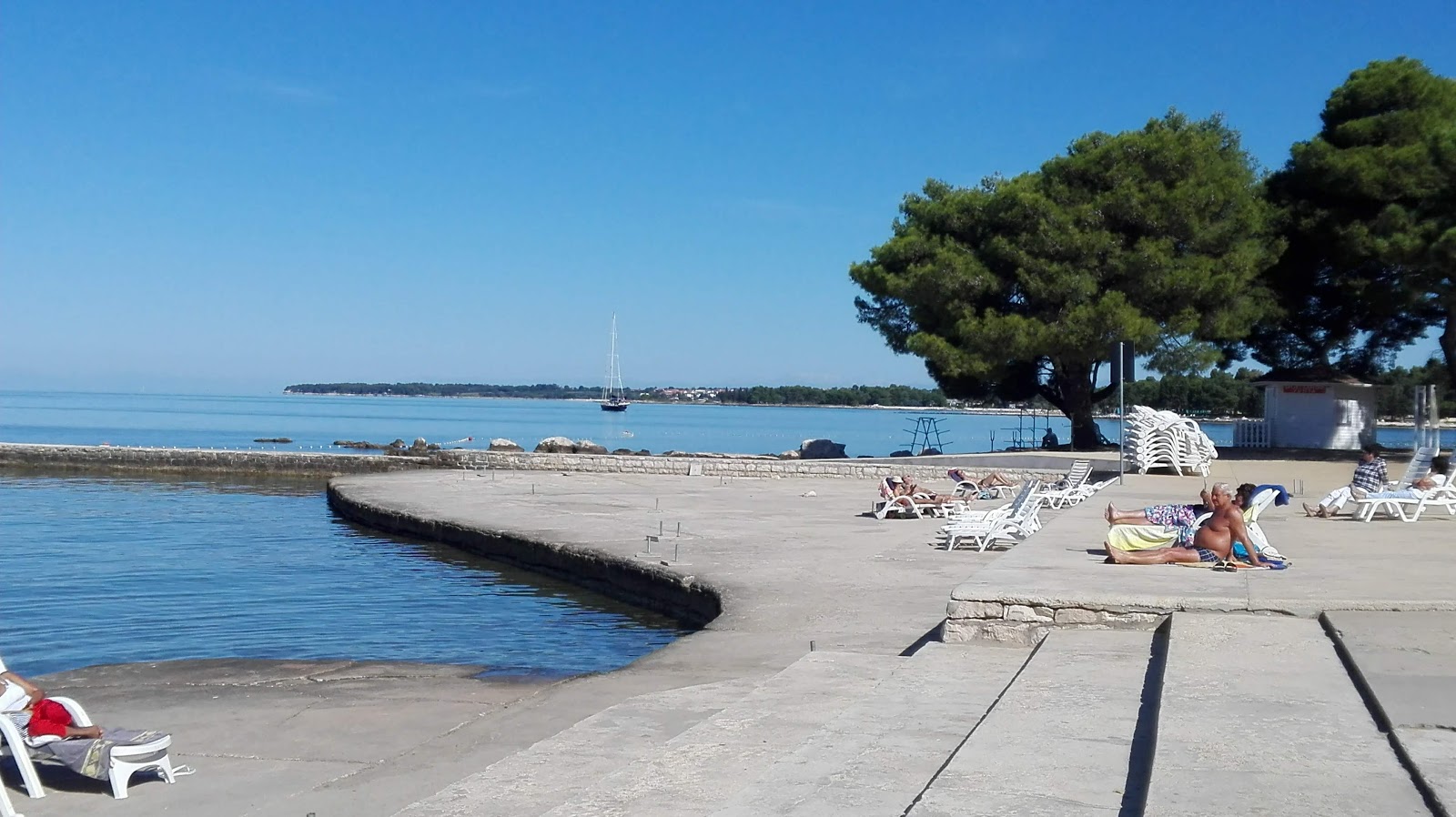 Photo of Umag Sandy beach and the settlement