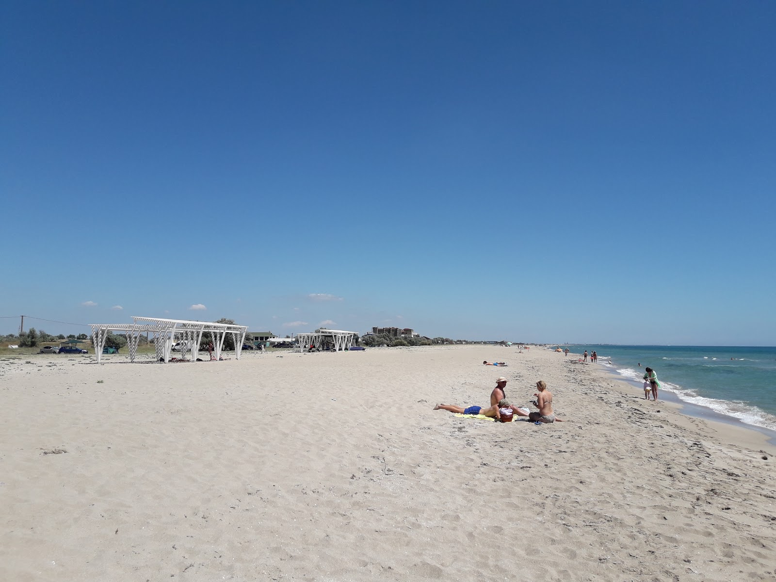 Foto von Kosa Belyaus mit langer gerader strand