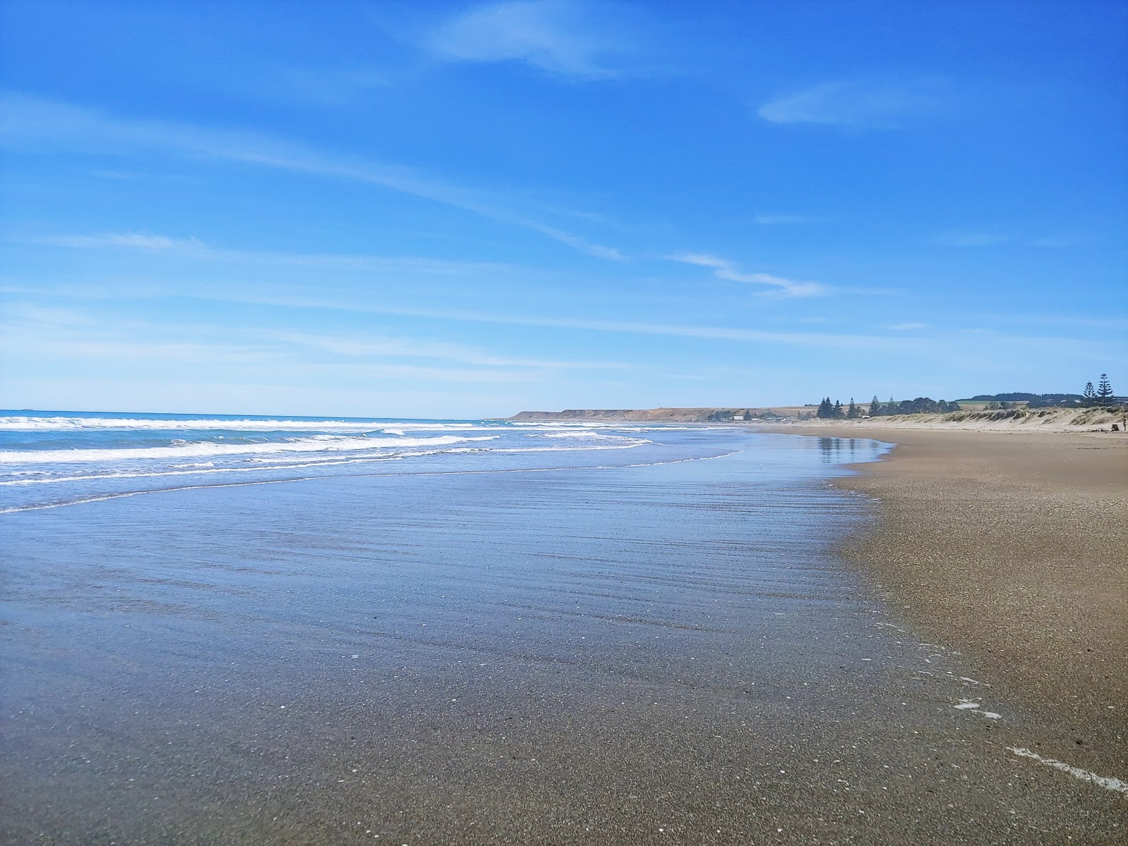 Fotografija Riversdale Beach z svetel pesek površino