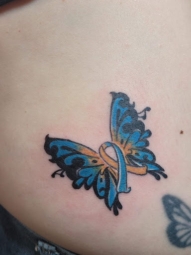 Explore charm tattoo ideas, creative tattoo ideas in Ocoee, available at Slaughterized Ink Tattoo and Piercing Studio