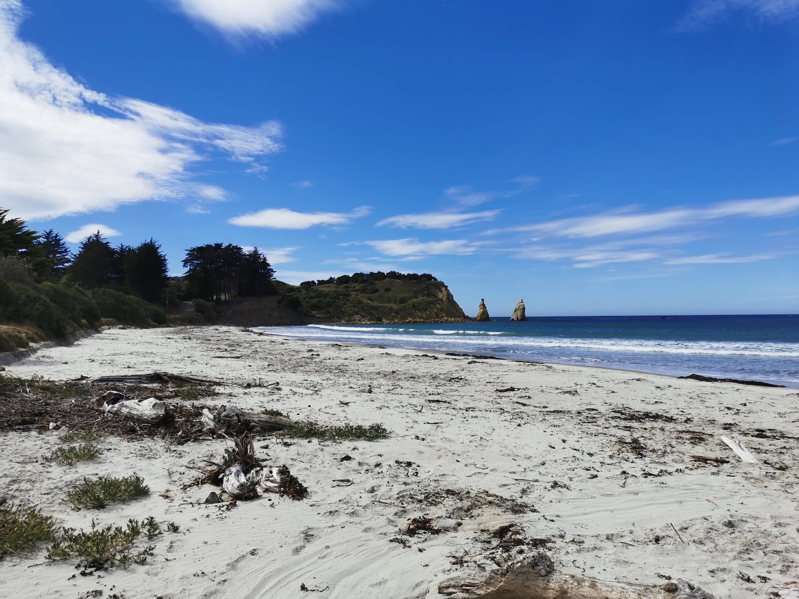 Foto av Karitane Beach med beige sand yta