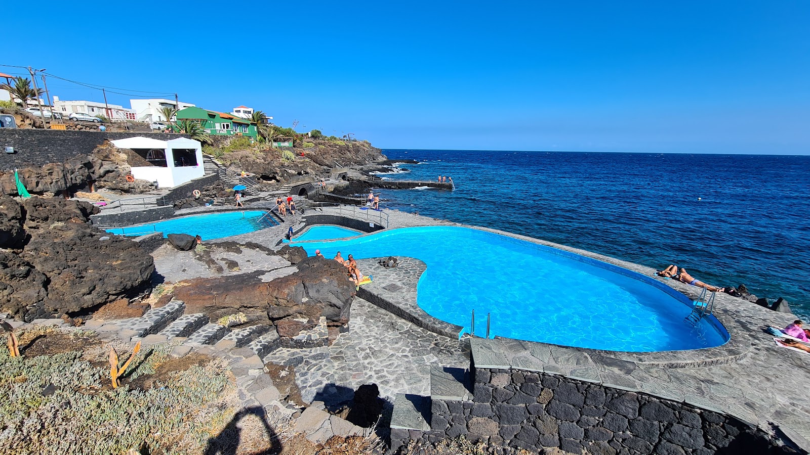 Photo of La Caleta Pools backed by cliffs