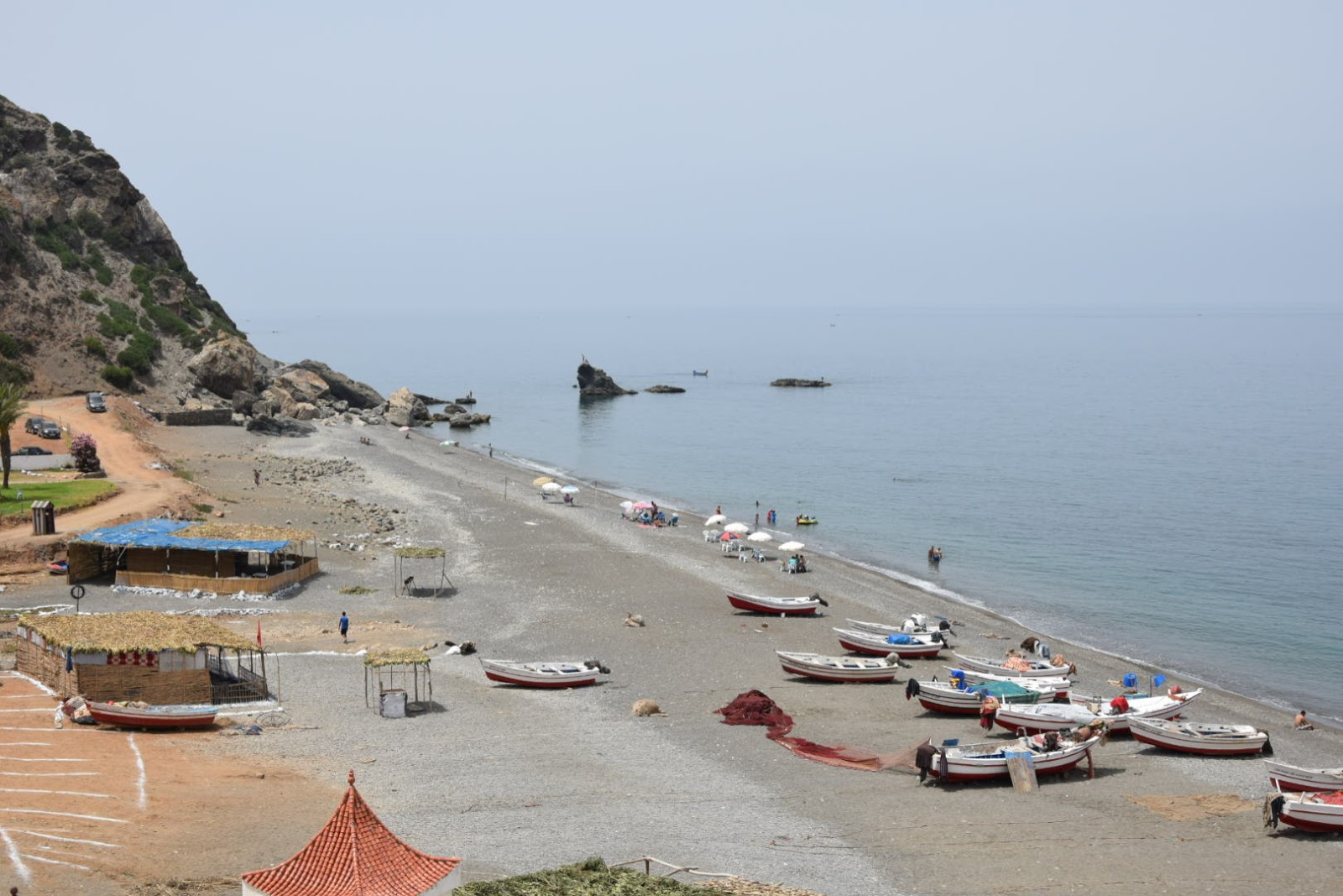 Foto von Plage Jnanich mit türkisfarbenes wasser Oberfläche