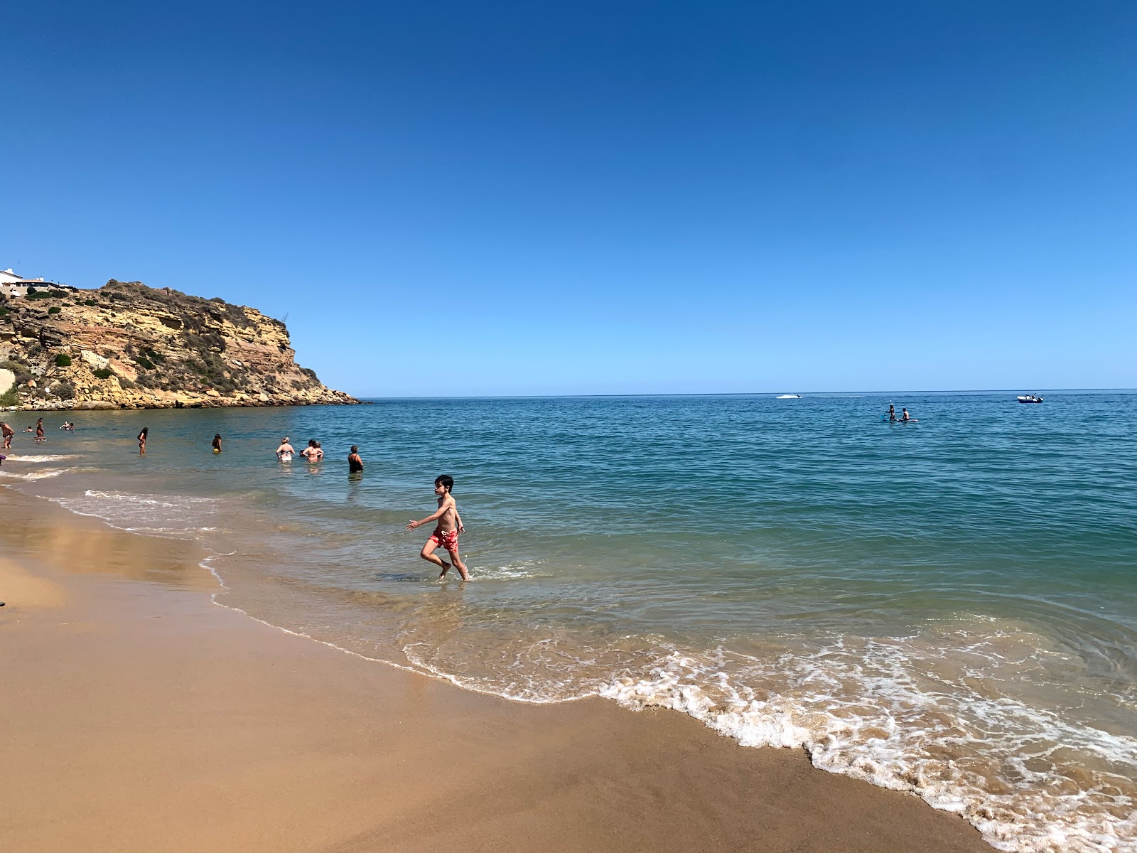 Foto van Praia do Burgau omringd door bergen