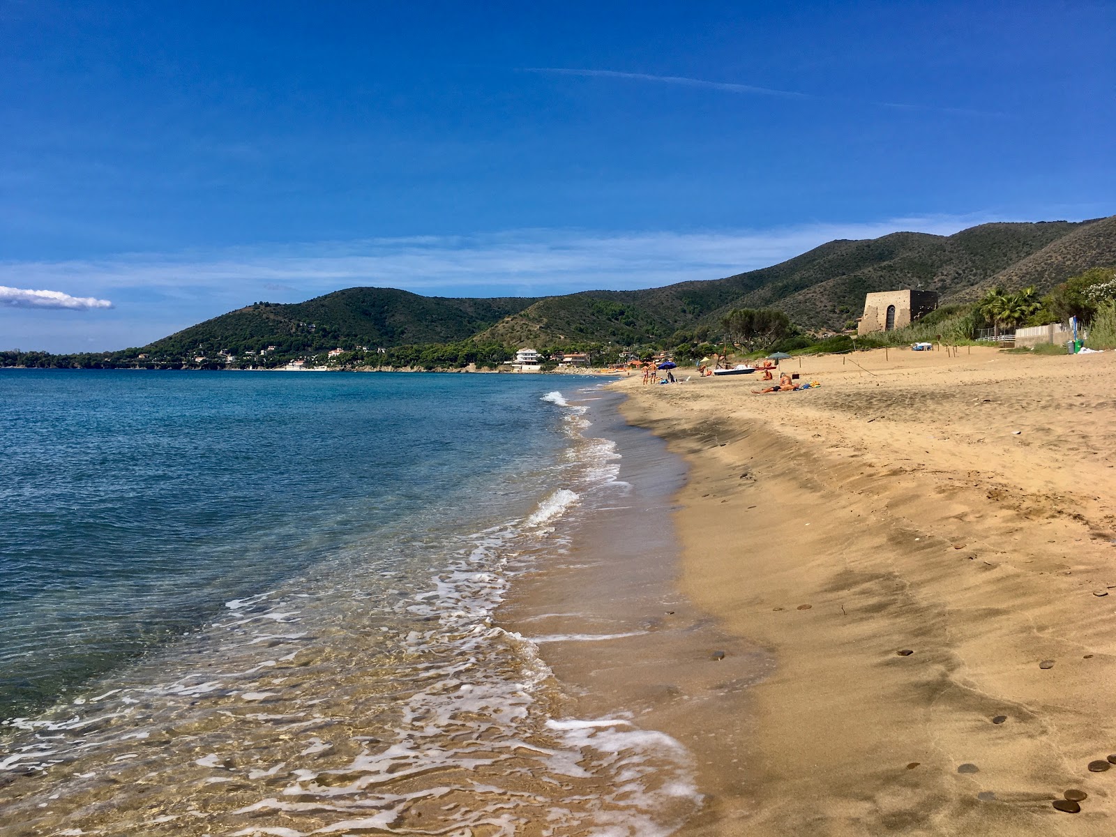 Photo of Spiaggia di Baia Arena with brown fine sand surface