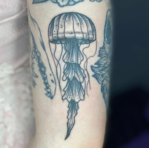 Explore stamp tattoo ideas, creative tattoo ideas in Mesa, available at Next Wave Tattoos and Piercings 2