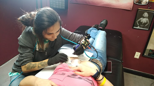 Explore cover up tattoo ideas for leg, creative tattoo ideas in Anniston, available at Wicked Game Tattoo & Piercing Studio