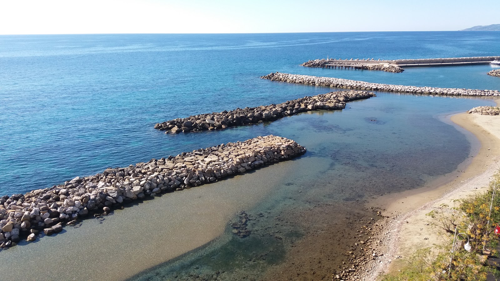 Photo of Annalì beach with blue water surface