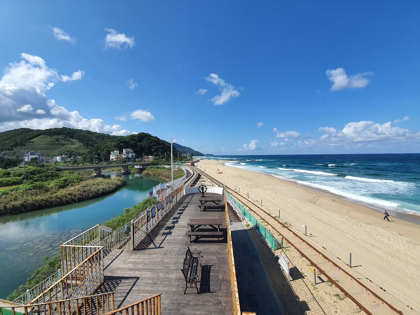 Foto av Jeongdongjin Beach omgiven av klippor