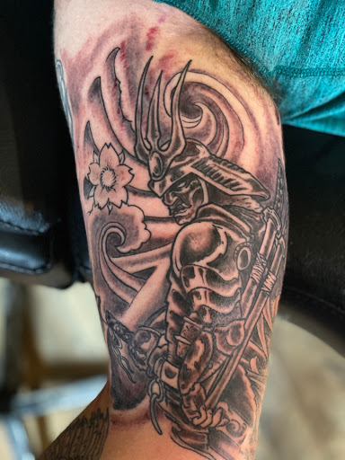 Explore bow hunting tattoo ideas, creative tattoo ideas in Pikeville, available at The Carbon Canary Tattoo Studio