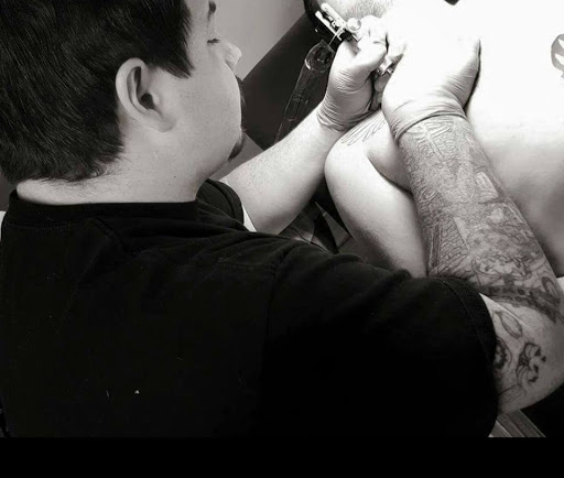 Explore lily tattoo ideas, creative tattoo ideas in New Bern, available at Firehouse Tattoo.