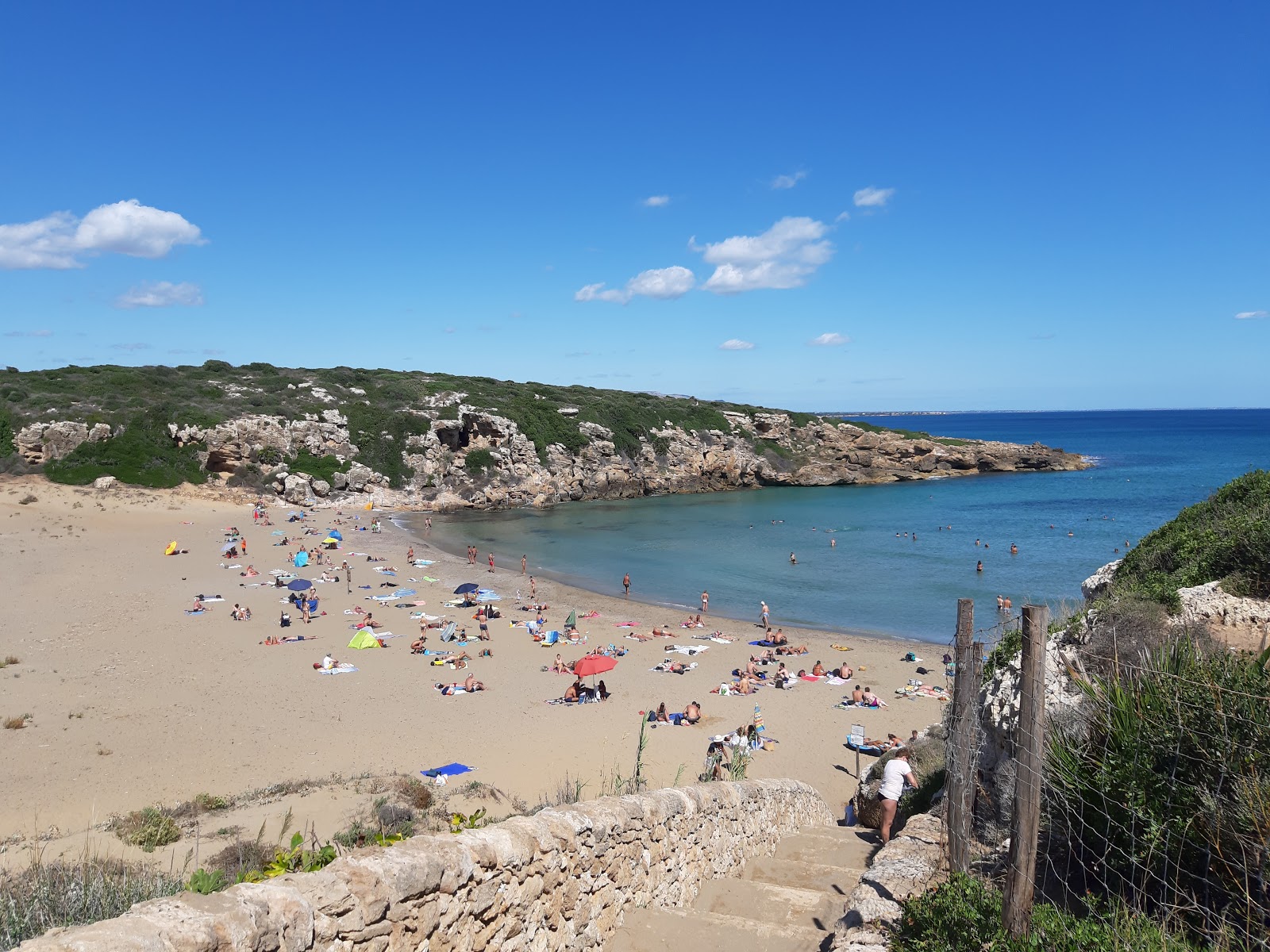 Spiaggia di Calamosche的照片 带有碧绿色纯水表面