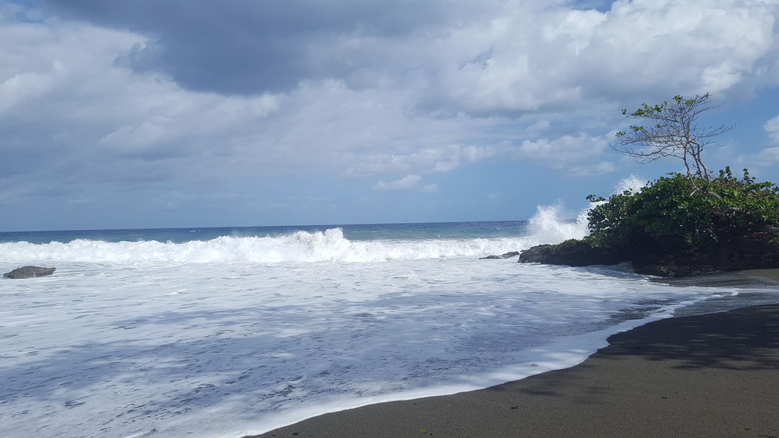 Foto van Playa Barigua met beige zand oppervlakte