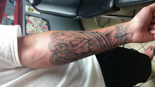 Explore tiger lily tattoo ideas, creative tattoo ideas in Myrtle Beach, available at Aces High Tattoo