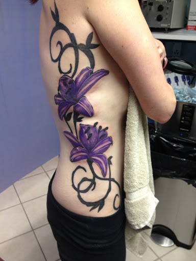 Explore chest tattoo lettering ideas, creative tattoo ideas in Spencer, available at Inkorporated Body Art