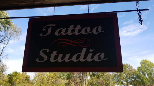 Explore disturbed tattoo ideas, creative tattoo ideas in Laurel, available at Ambitious Creations Tattoo and Piercing Studio