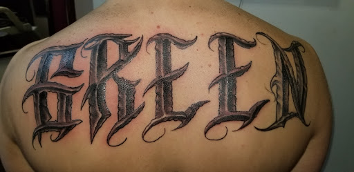 Explore name cover up tattoo ideas for men, creative tattoo ideas in Angola, available at Hoodlum Ink